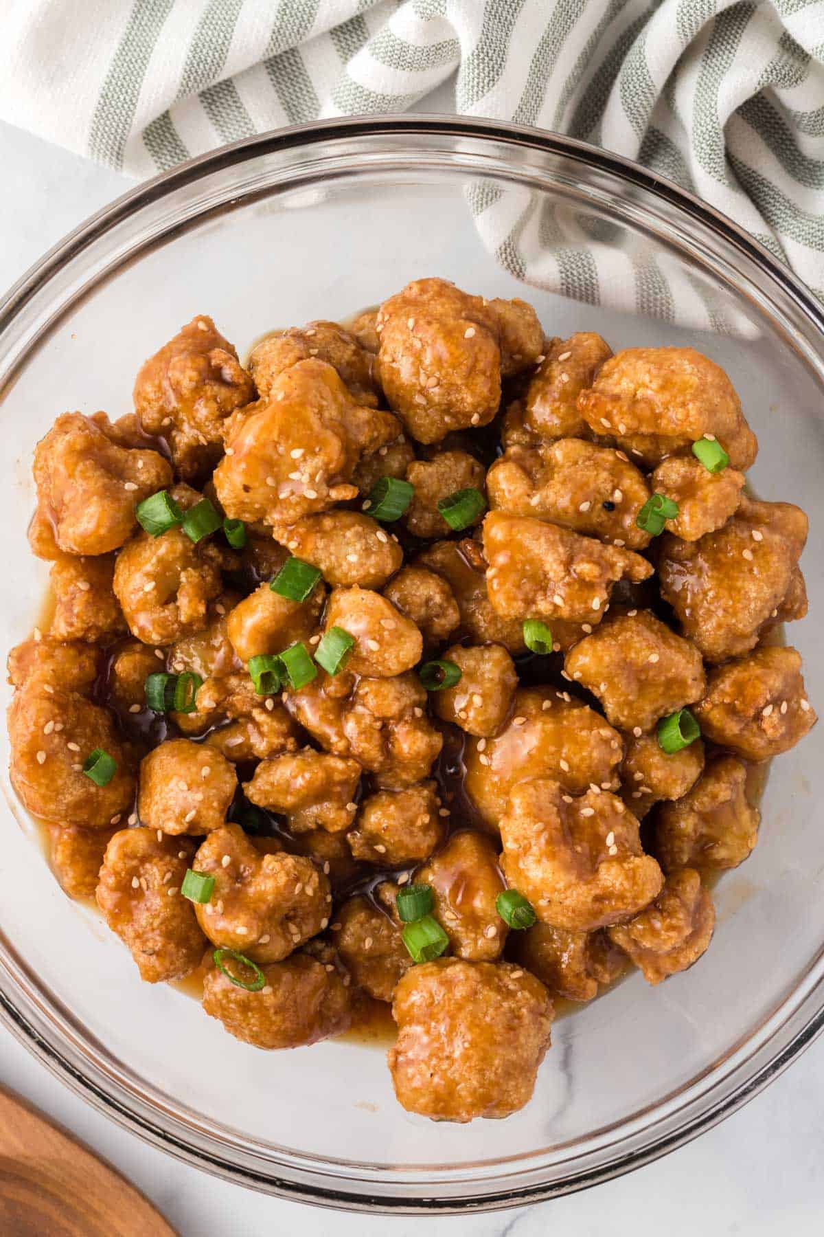 orange cauliflower in a bowl topped with green onions