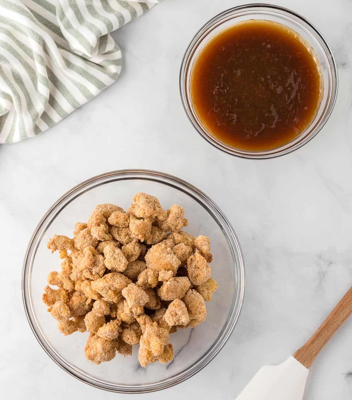 breaded cauliflower next to orange sauce