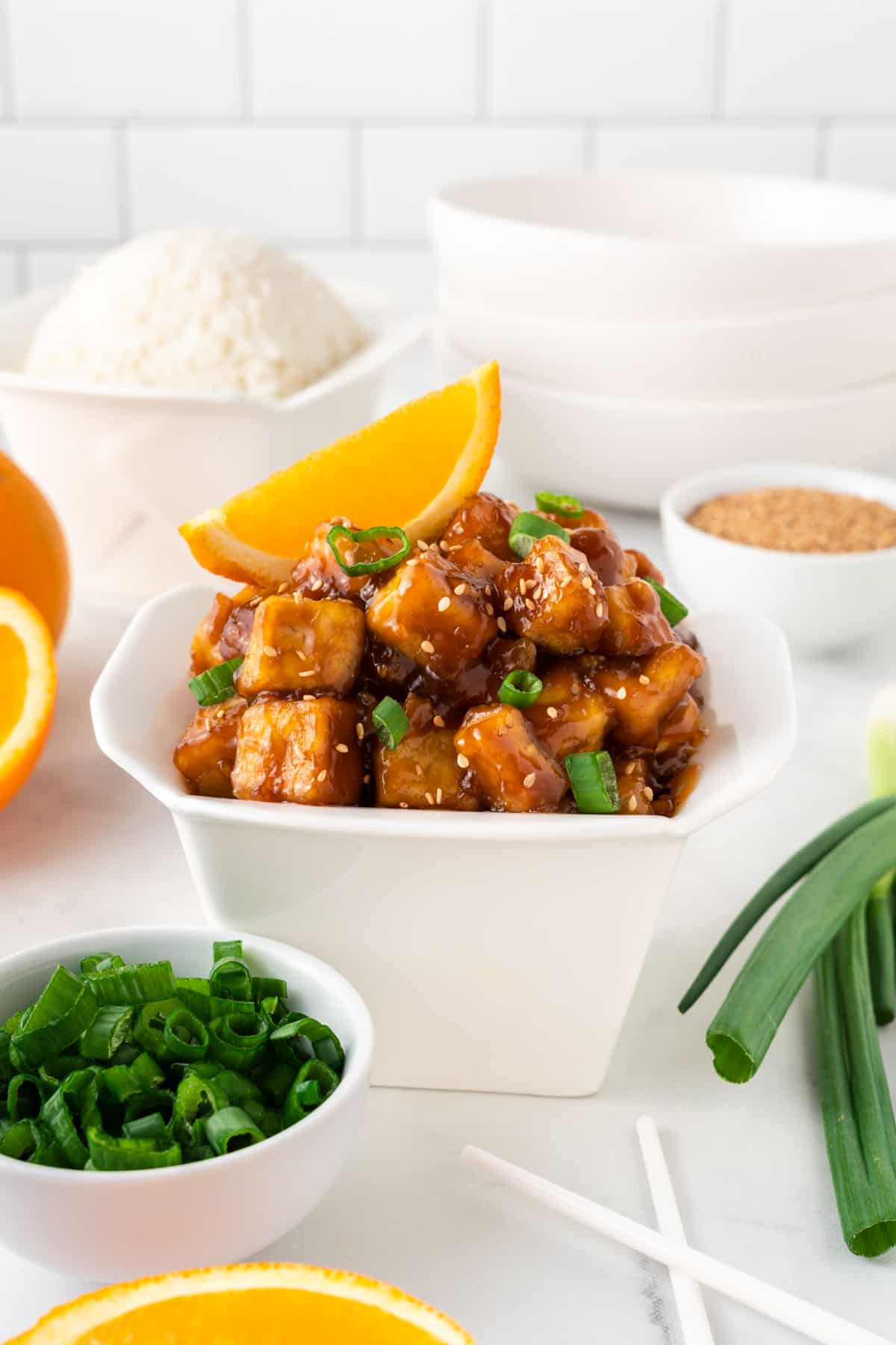 orange tofu in a takeout container