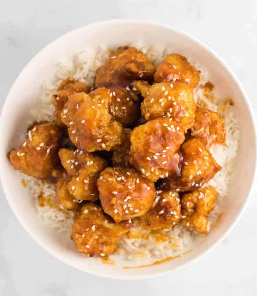 orange cauliflower over rice in a bowl