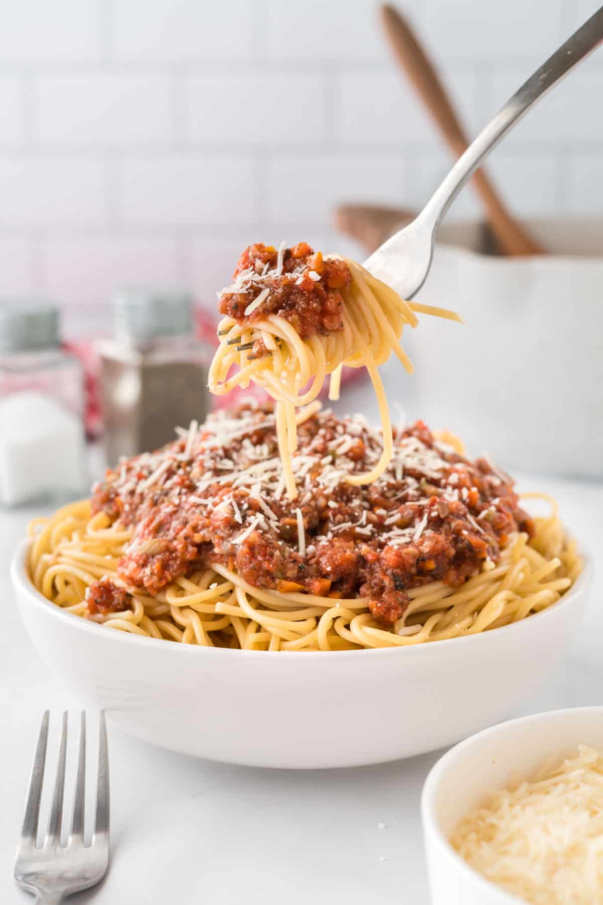 fork taking a bite of spaghetti with vegetarian bolognese