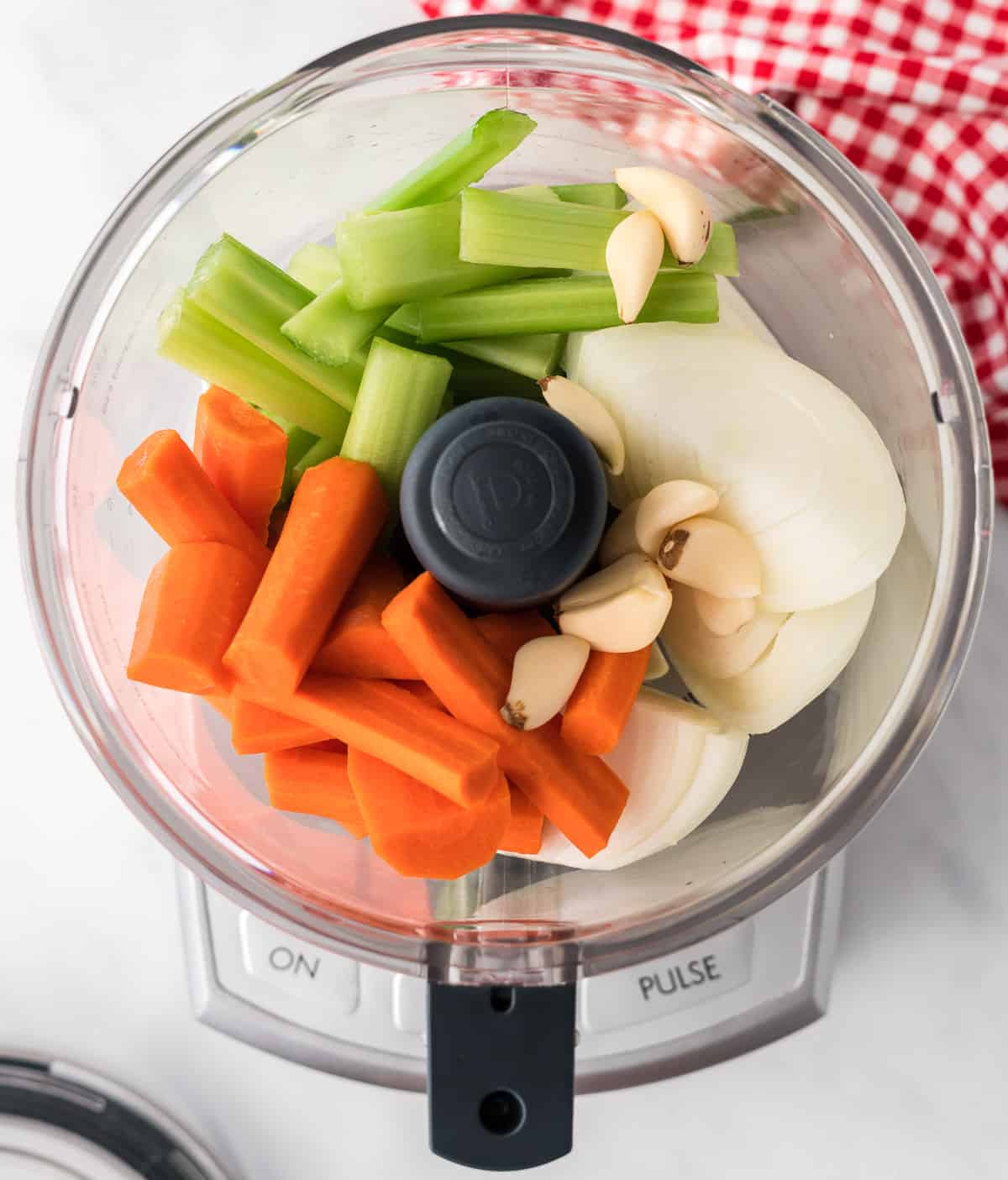 celery, garlic, carrots, and onion in a food processor