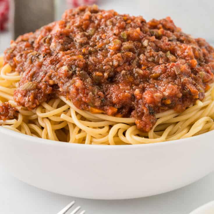 bowl of spaghetti topped with vegetarian bolognese sauce