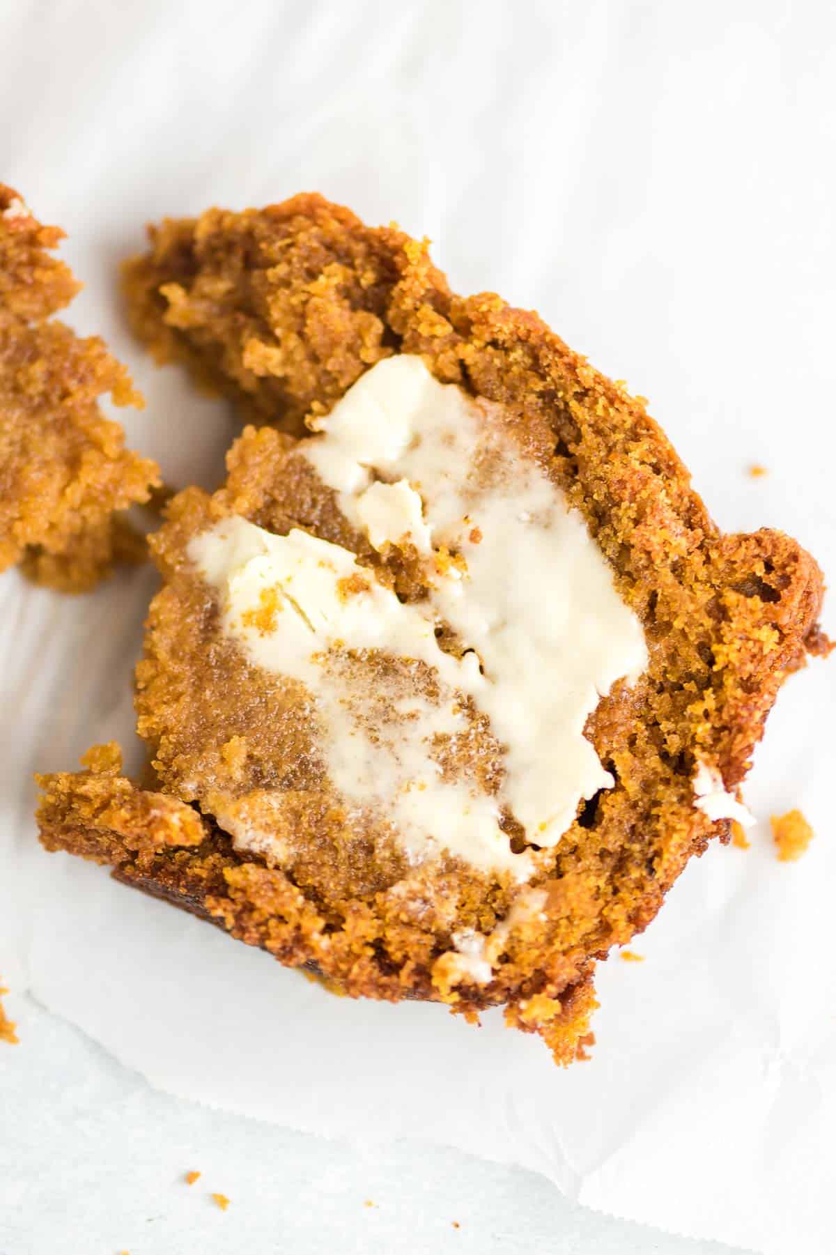 a slice of pumpkin bread from scratch smeared with melting butter