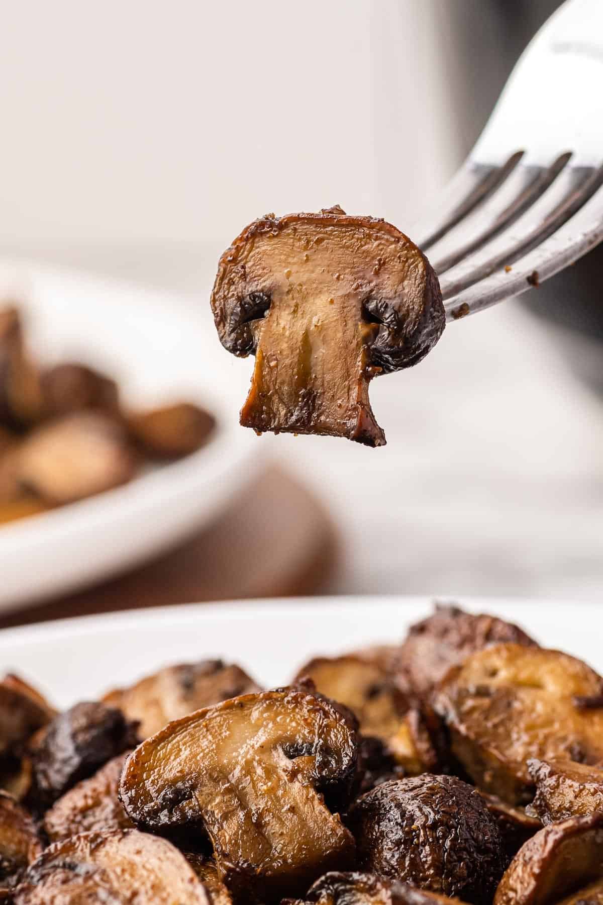 a fork holding a mushroom