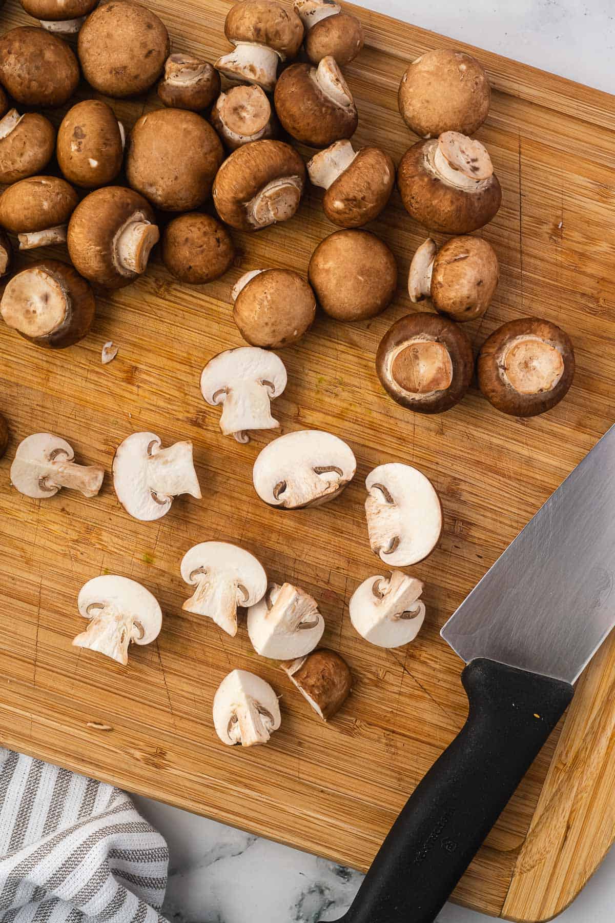 cutting the mushrooms on a cutting board