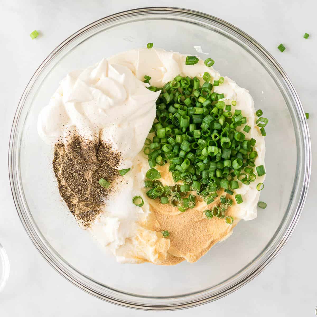 cream cheese, sour cream, green onions, and spices in a bowl