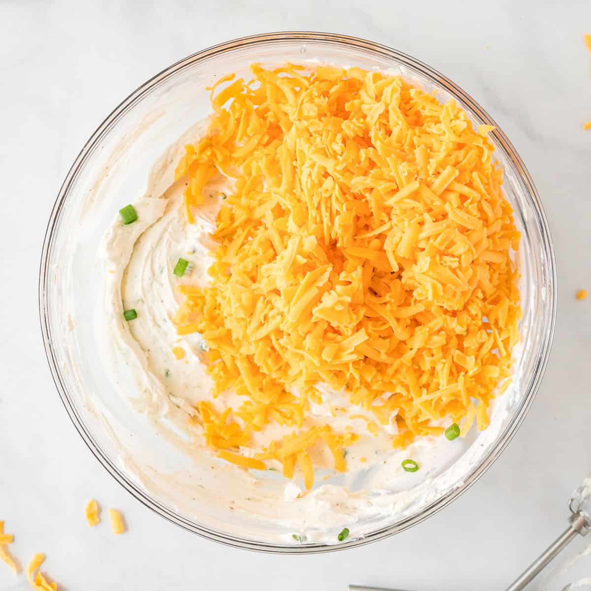 shredded cheddar added to the cheese ball ingredients