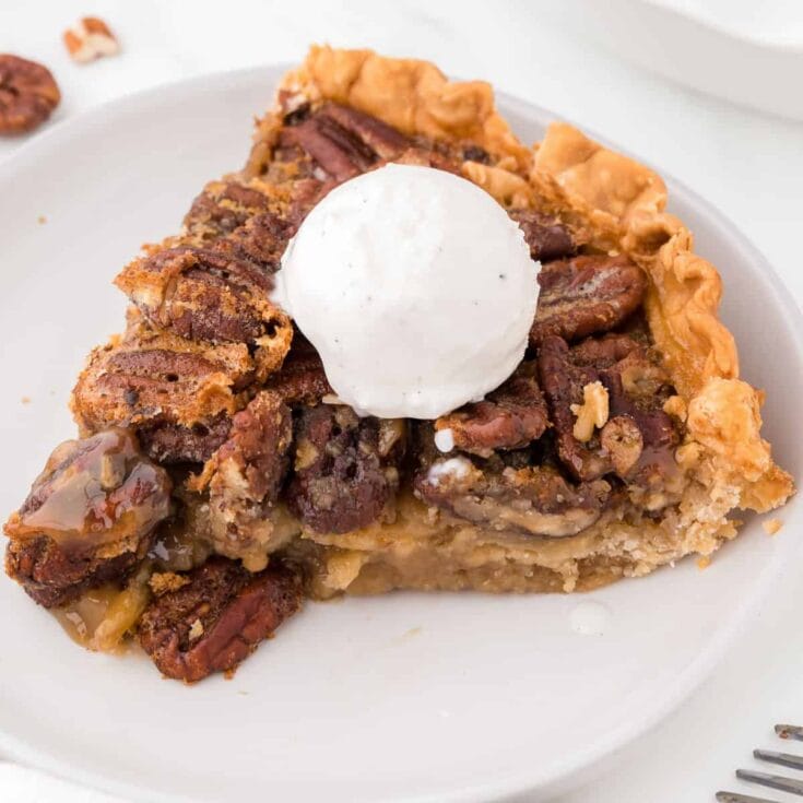 slice of maple pecan pie topped with a scoop of ice cream