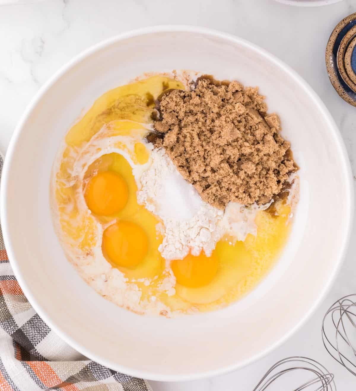 adding the brown sugar, eggs, and flour