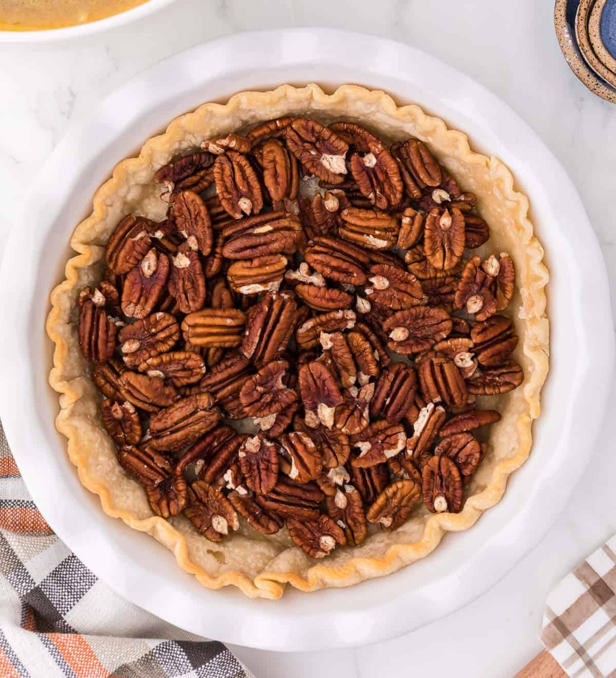 whole pecans inside a pie crust