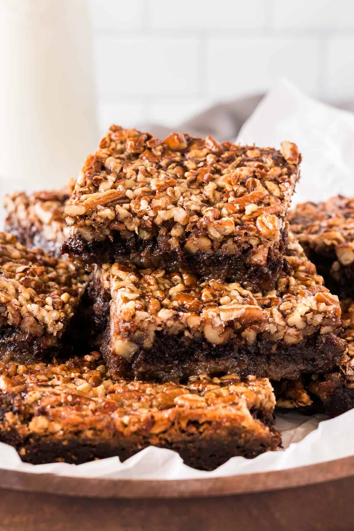 pecan pie brownies cut into squares and stacked on a plate