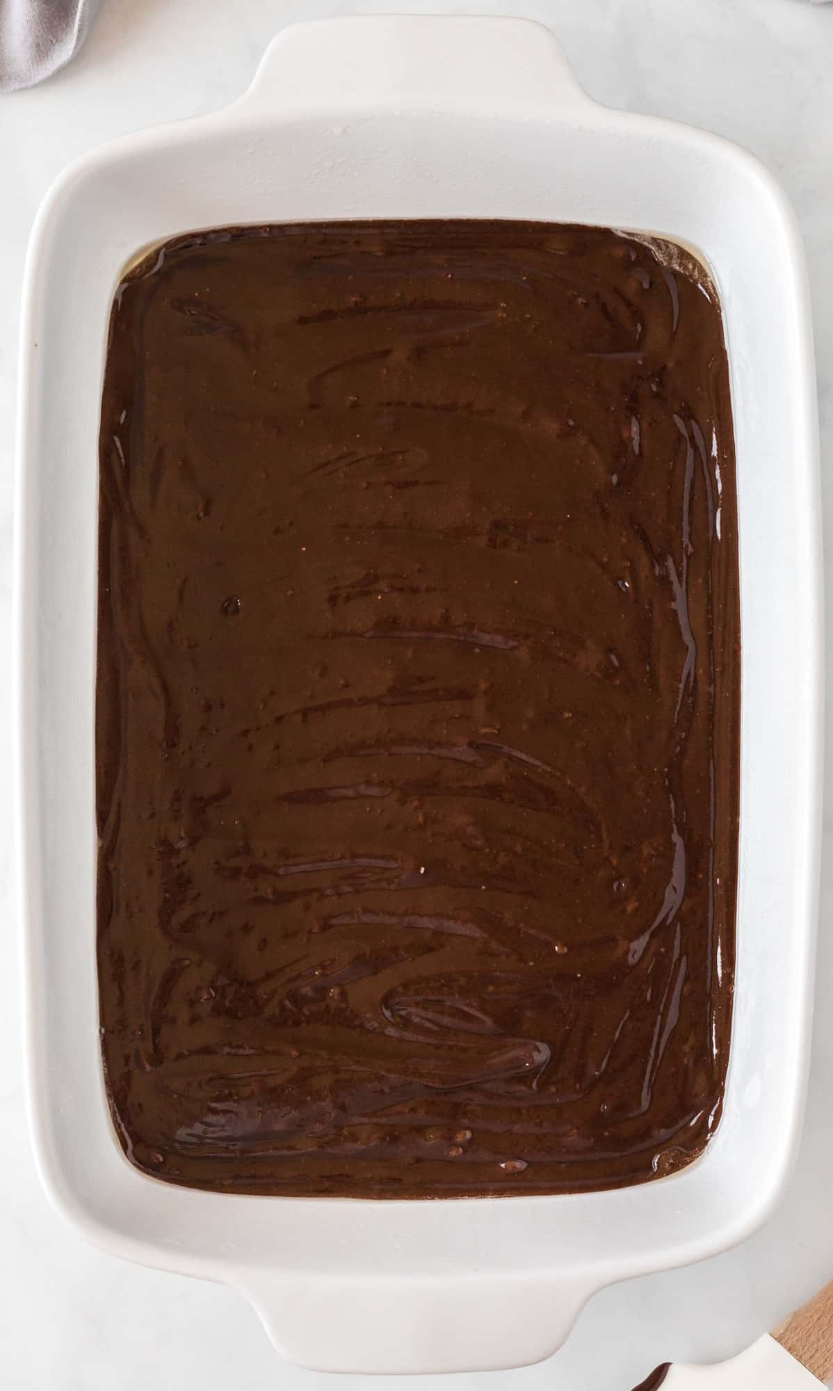 brownie mix spread out in a 9 by 13 baking dish