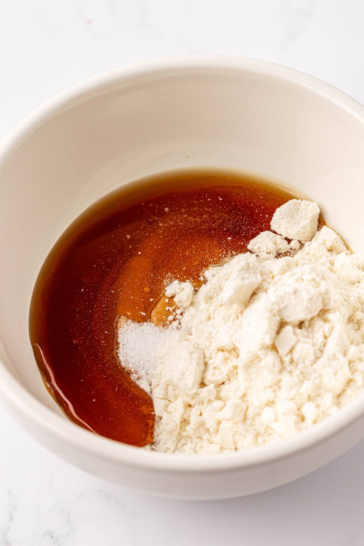 protein powder and maple syrup in a bowl