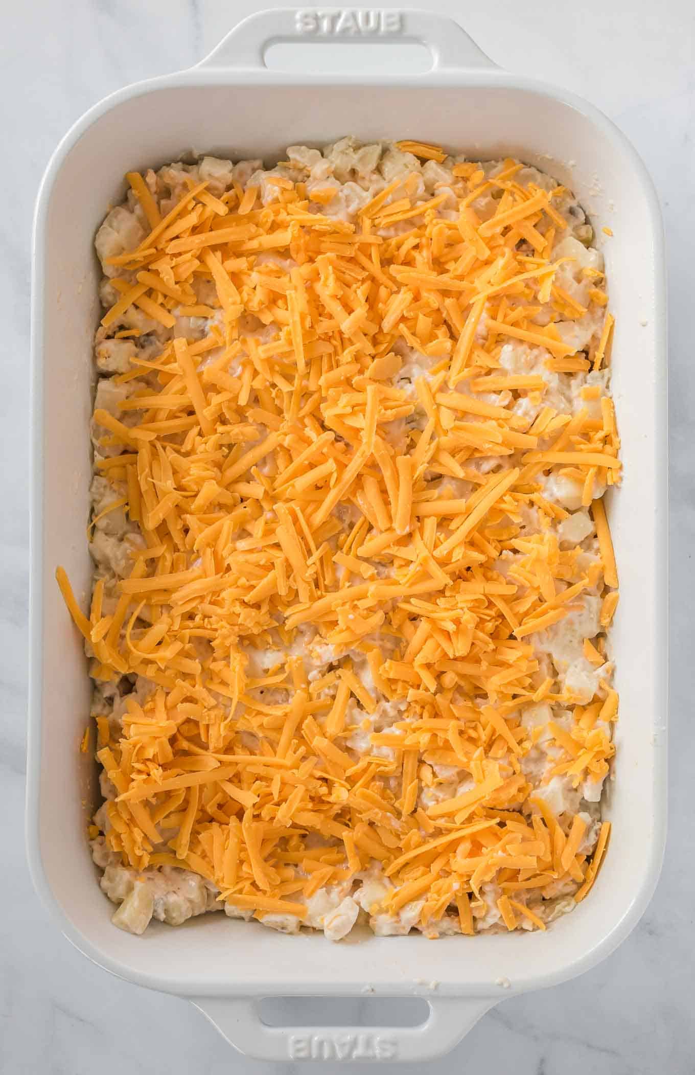 sprinkled fresh cheddar cheese on top of the funeral potato filling