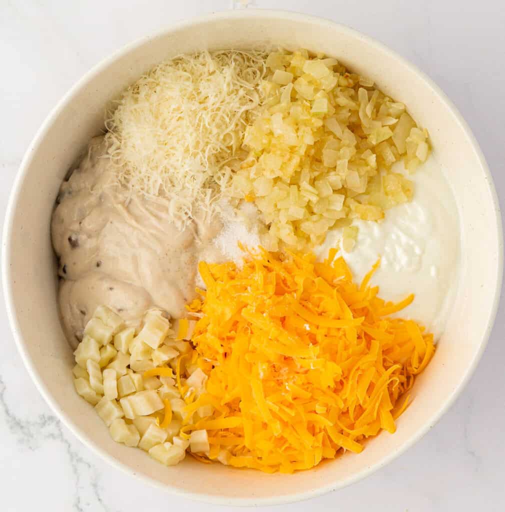 funeral potatoes ingredients in a mixing bowl