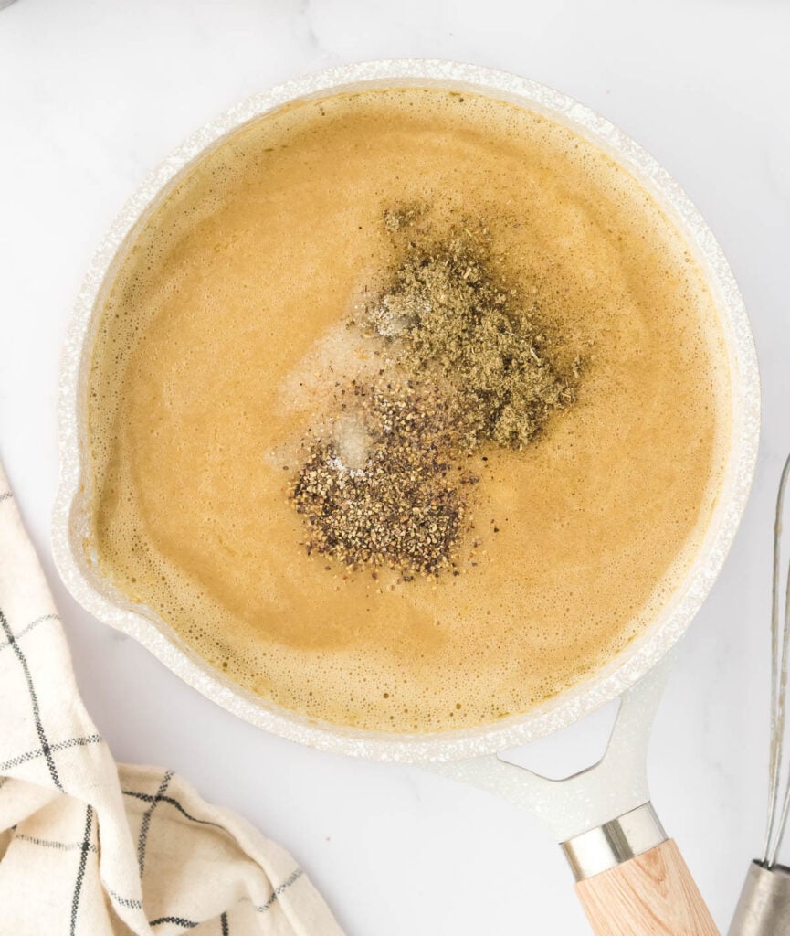 adding spices to the mushroom gravy