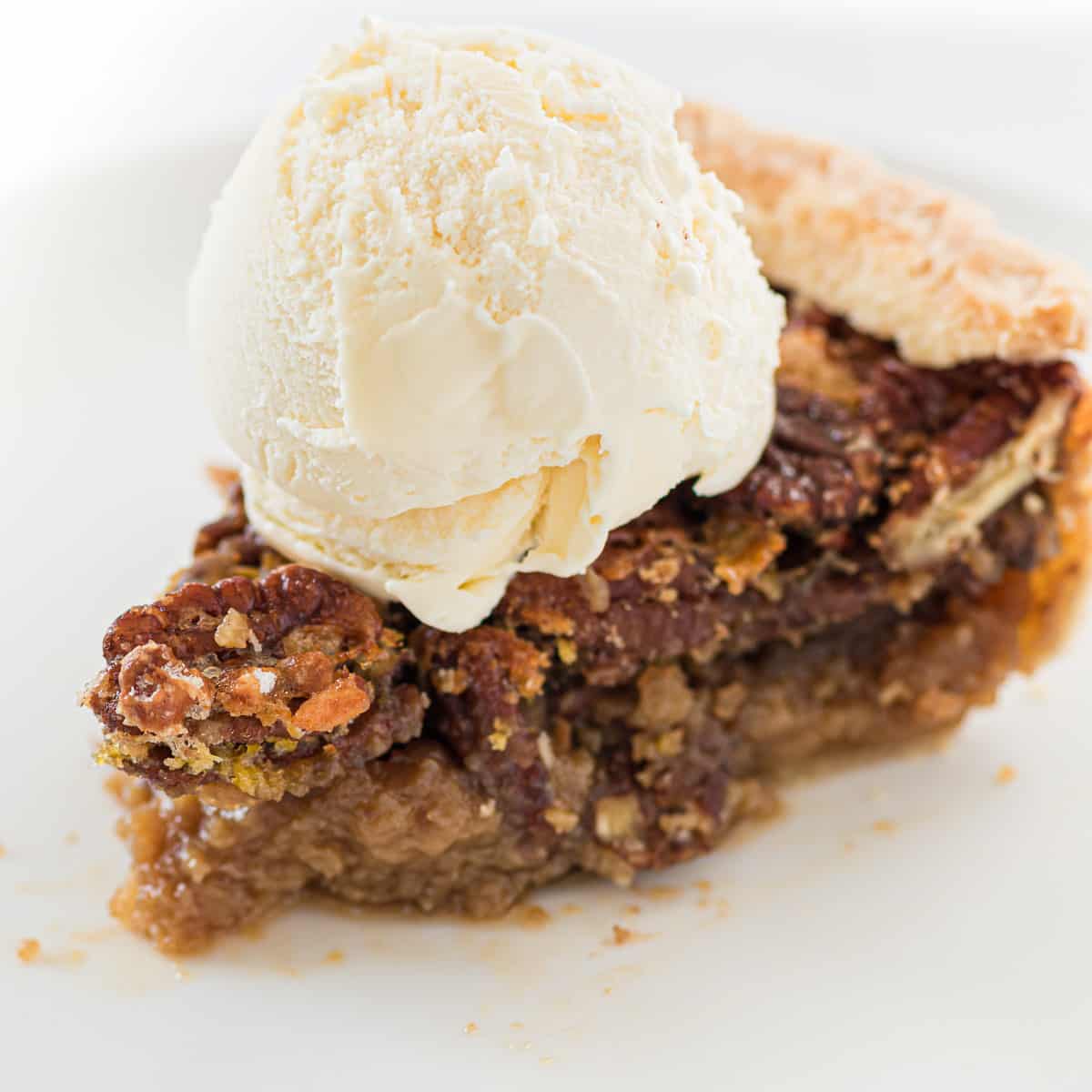 slice of pecan pie topped with ice cream