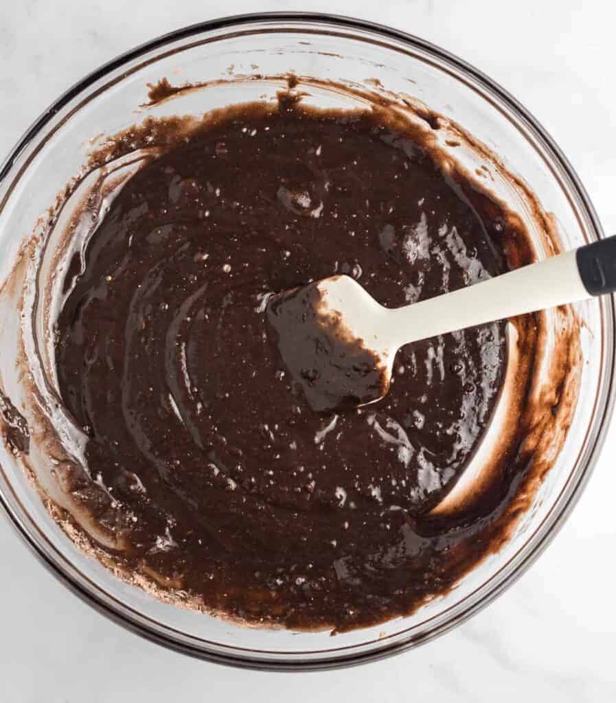 brownie batter in a bowl with a white spatula
