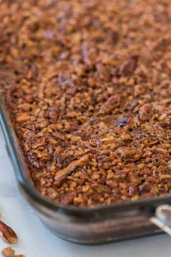 up close texture of the cooked pecan filling on top of the brownies
