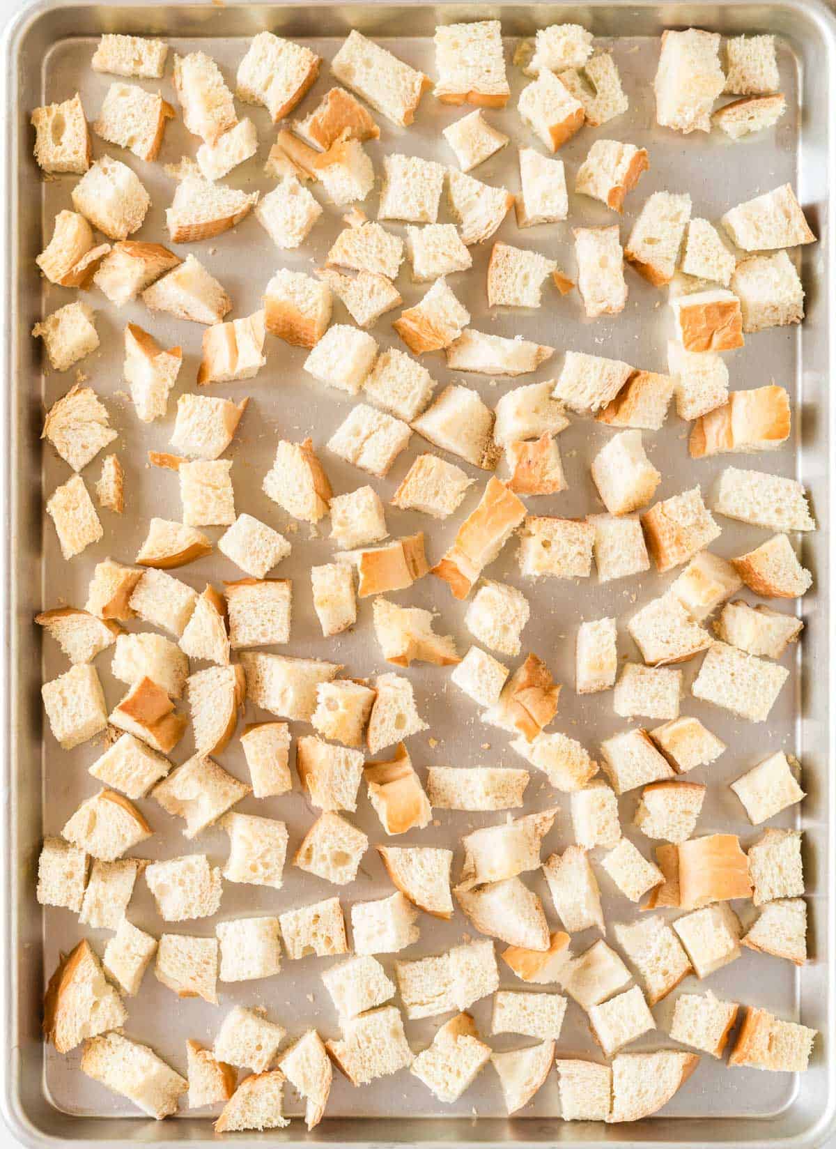 bread cubes on a baking sheet