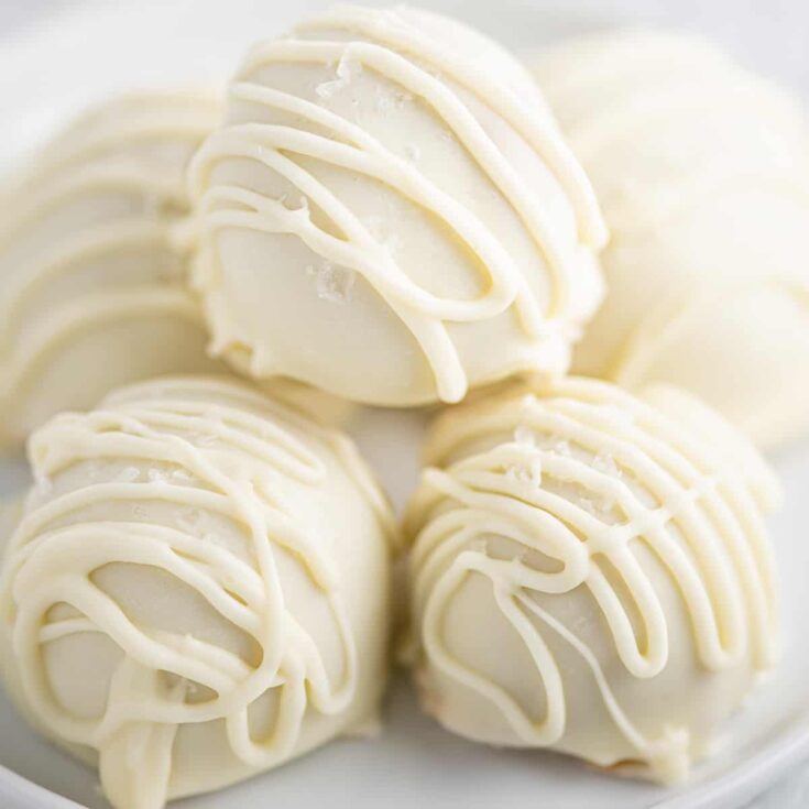 white chocolate balls stacked on a white plate