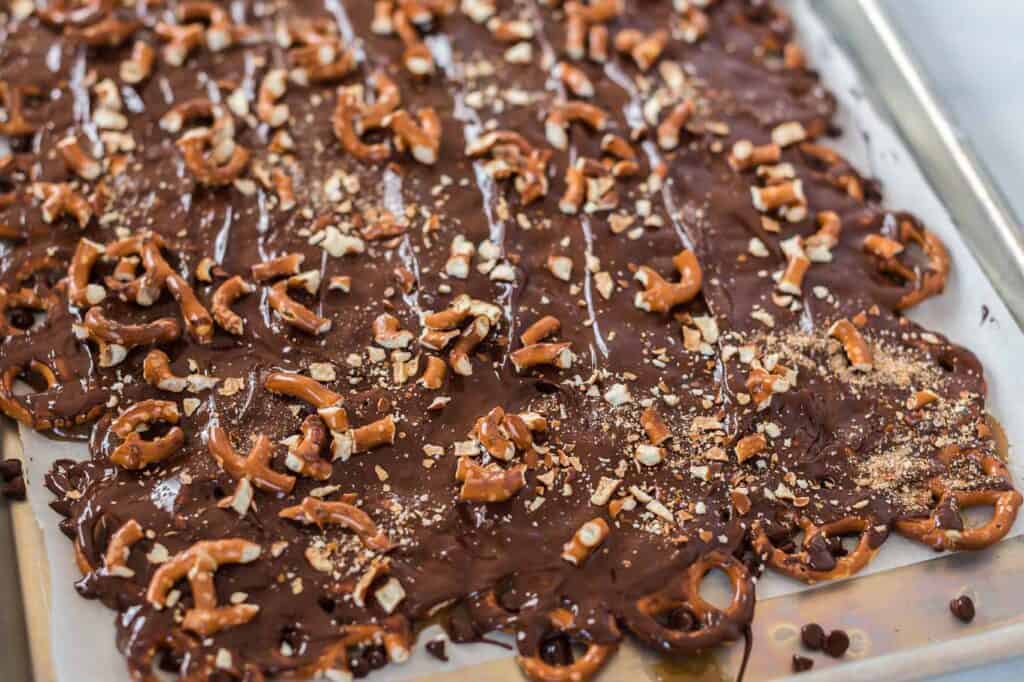 melted chocolate over the pretzels topped with crushed pretzels on top