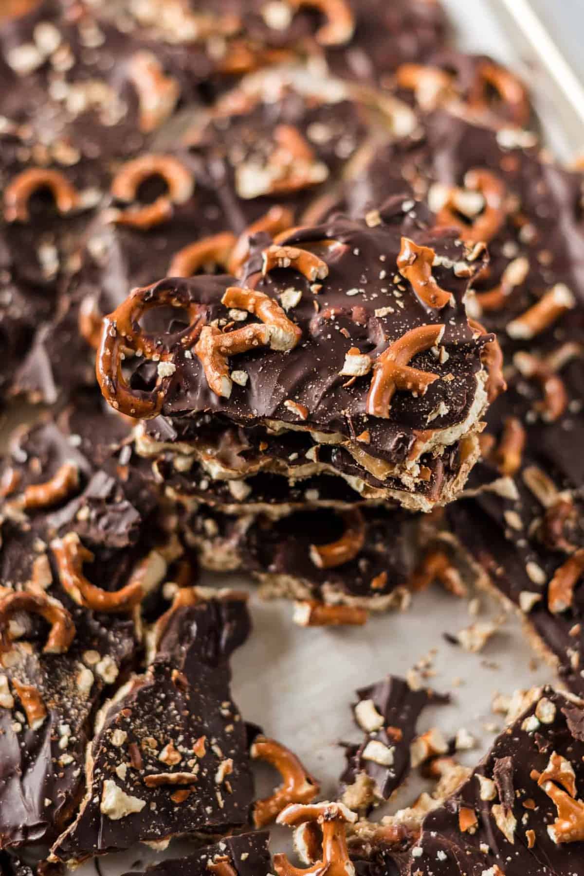 the finished chocolate caramel pretzel bars stacked on the baking sheet