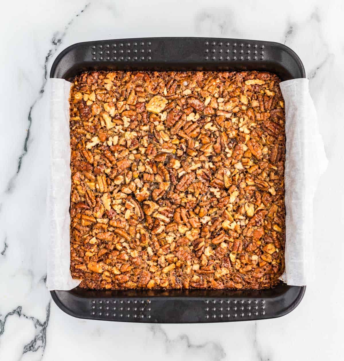 pecan pie bars in an 8 by 8 baking dish