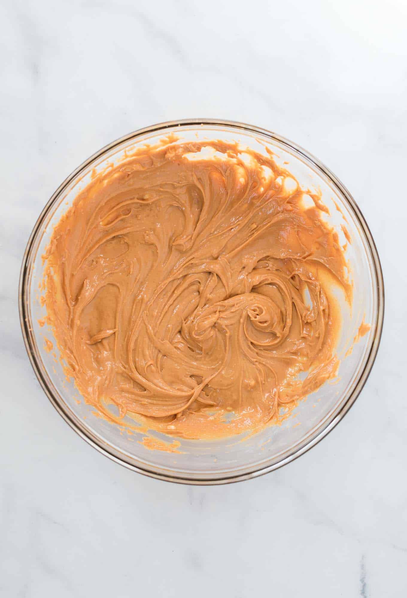 whipped peanut butter in a glass mixing bowl