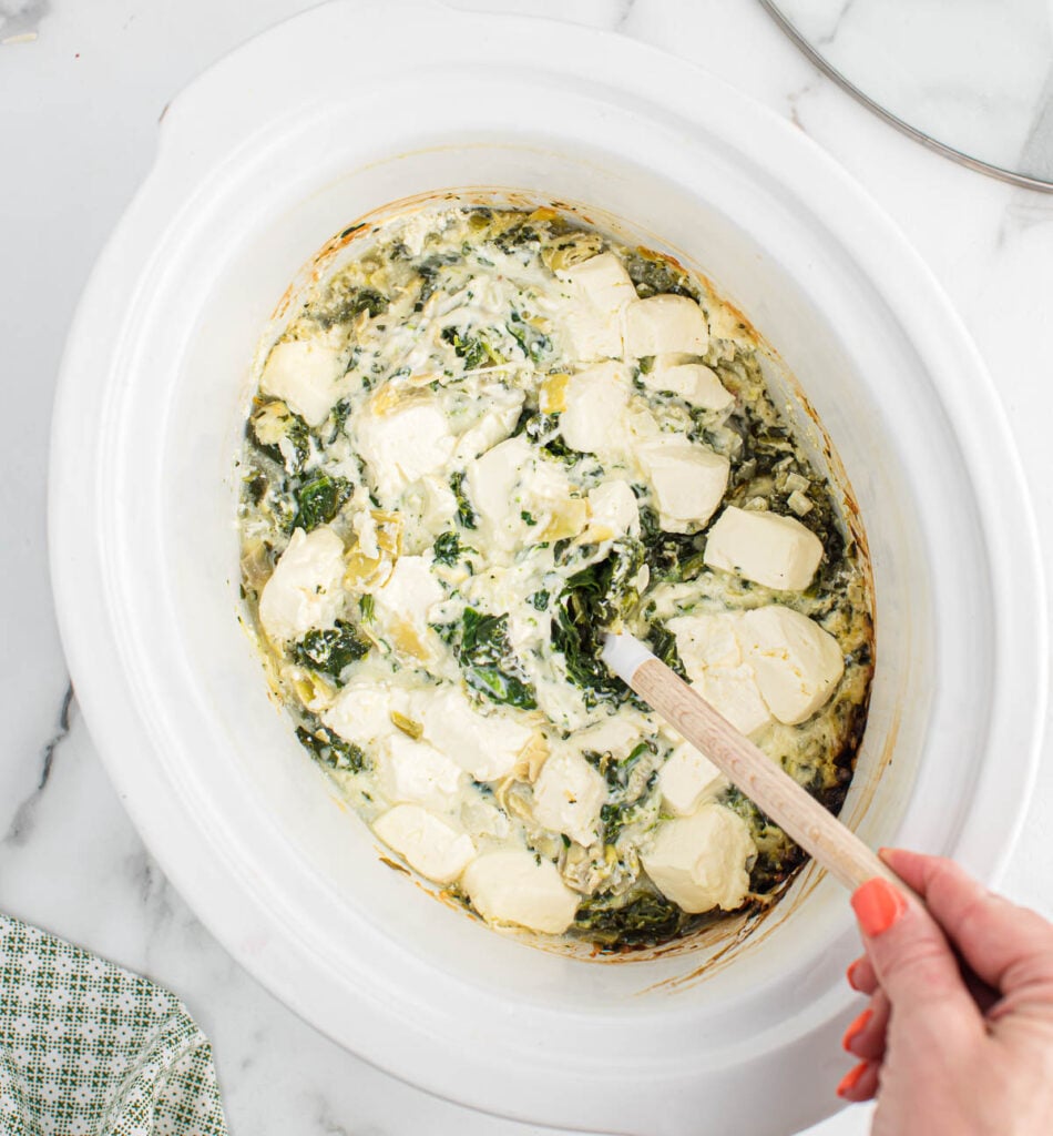 stirring the cream cheese into the dip