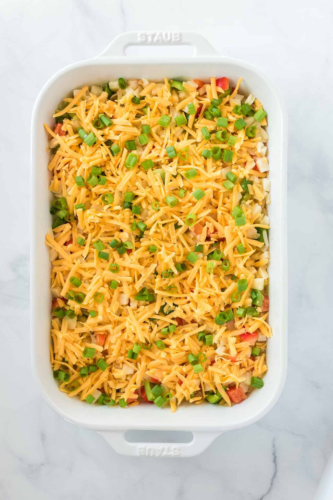 casserole topped with sharp cheddar cheese and green onions