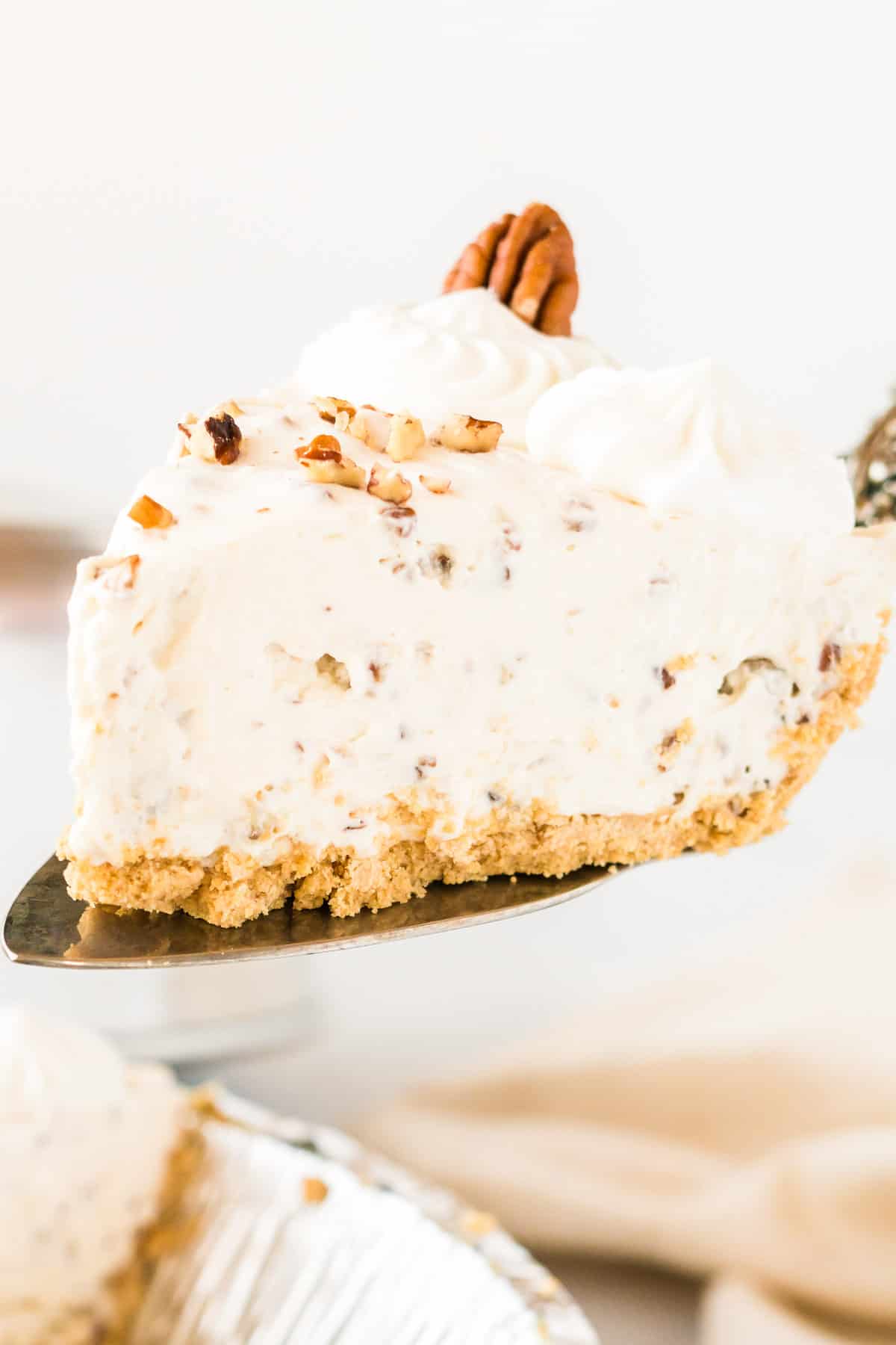 taking a slice of pecan cream pie from the dish