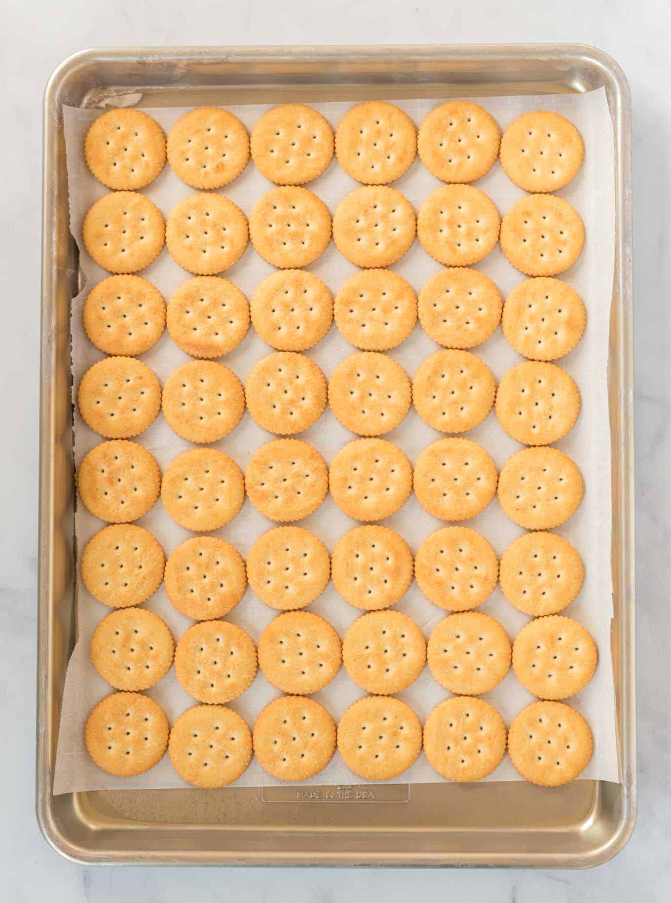 a baking sheet lined with ritz crackers