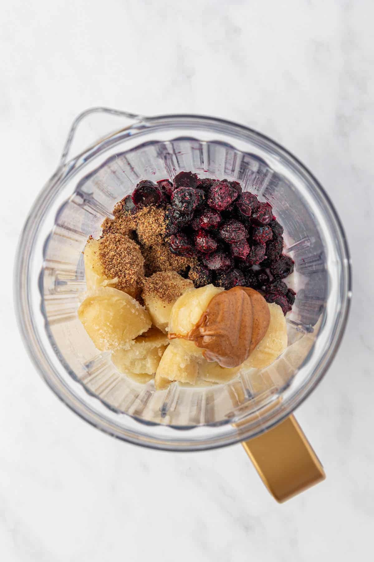 blueberry banana smoothie ingredients in a blender