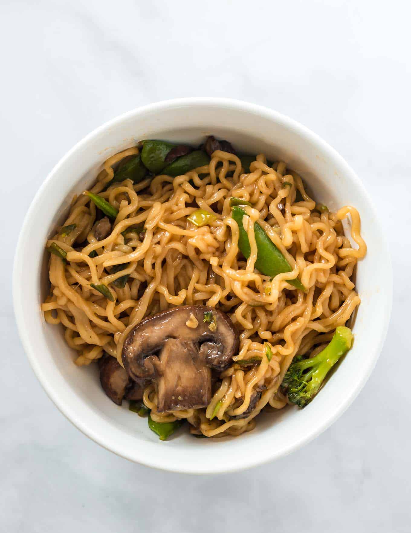 ramen noodles with vegetables in a white bowl