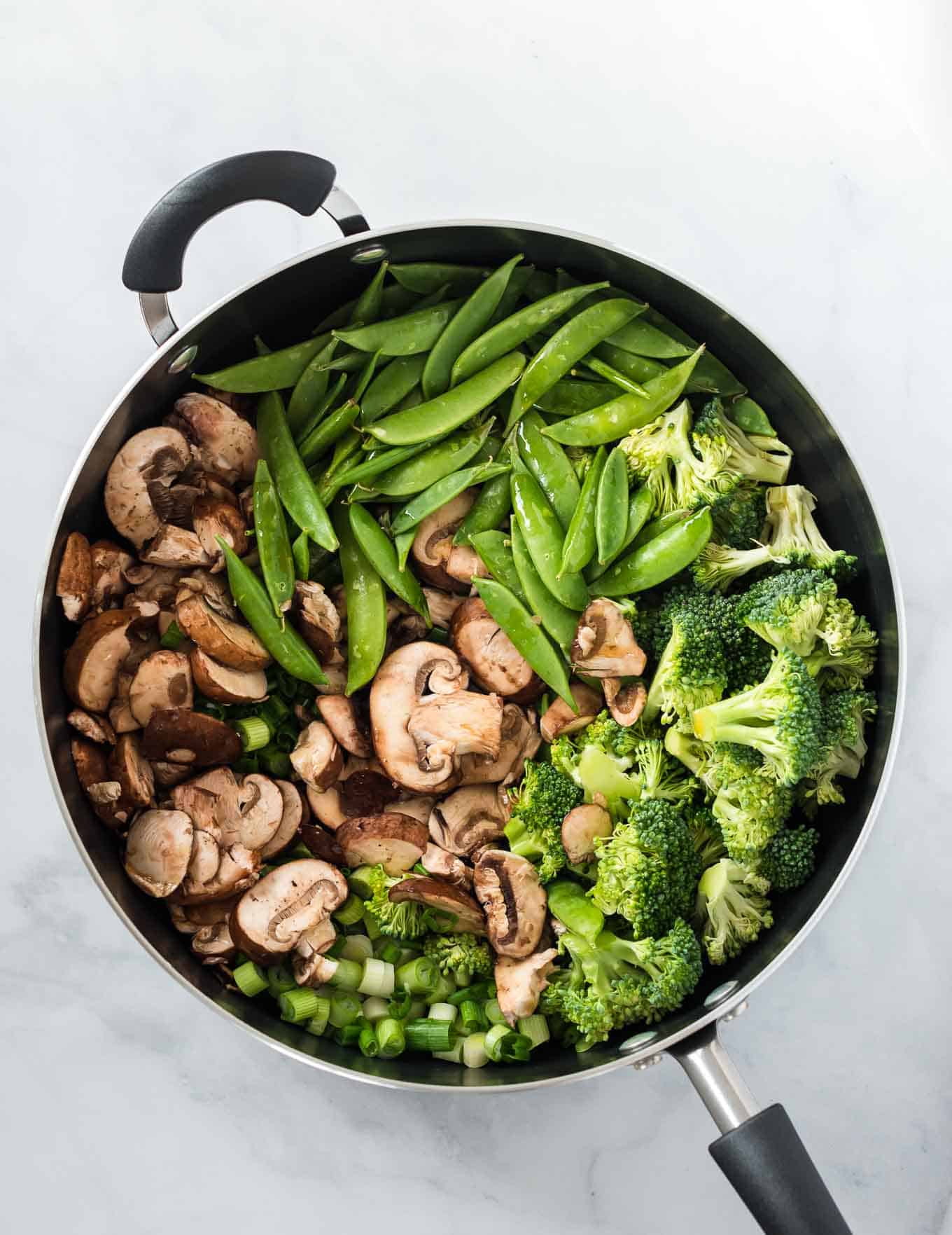 mushrooms, sugar snap peas, broccoli, and green onions in a large skillet