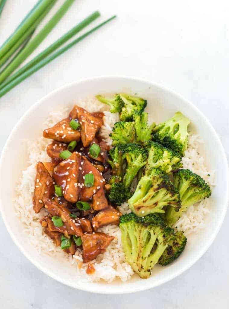 teriyaki tofu with broccoli over white rice in a bowl
