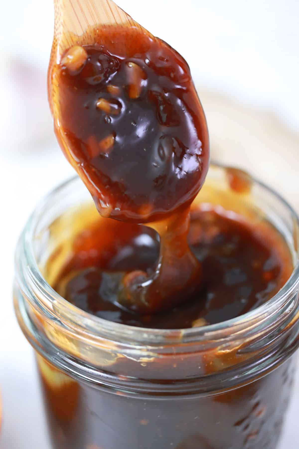 wooden spoon dripping teriyaki sauce