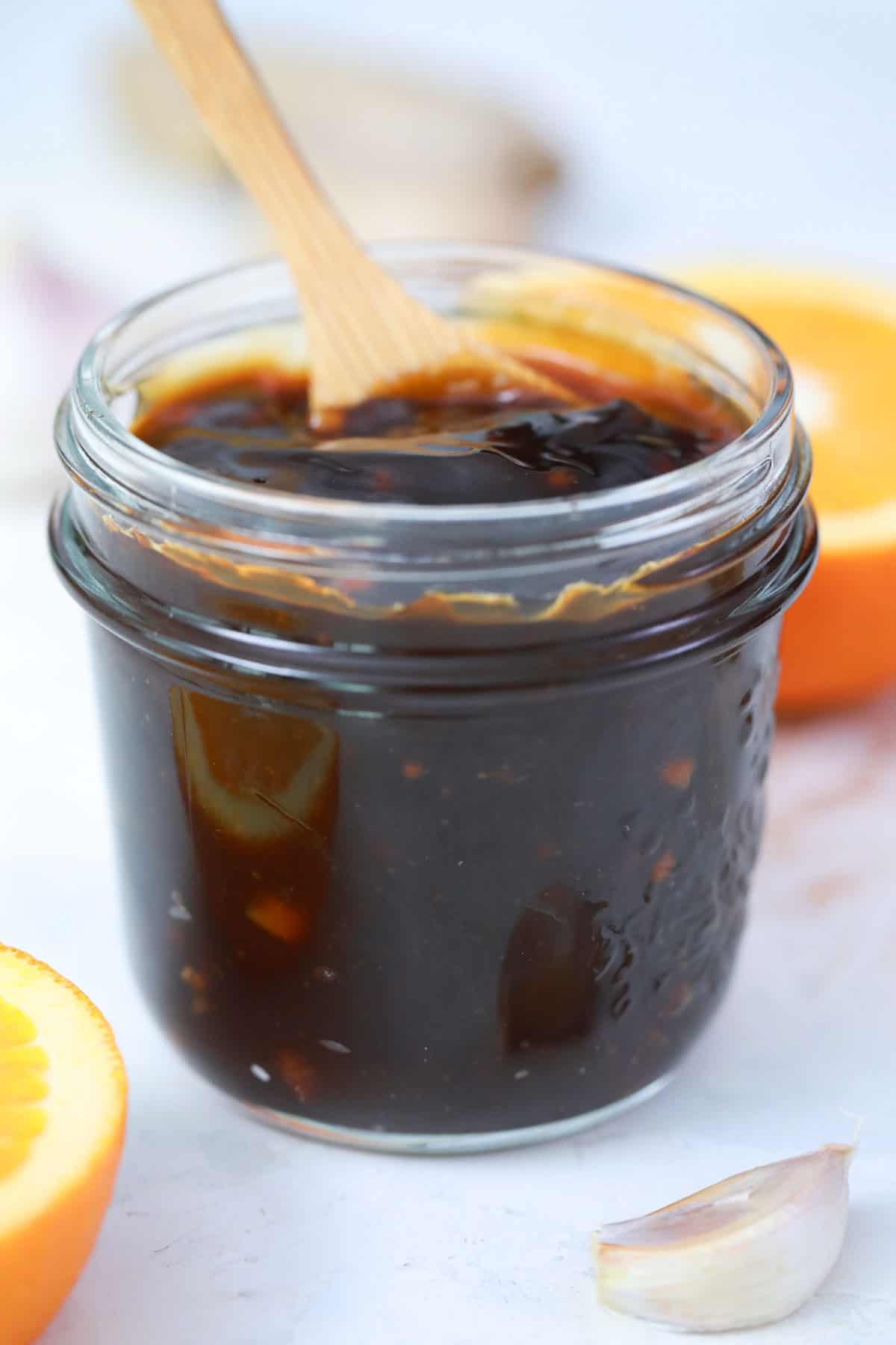 teriyaki sauce in a jar with a wooden spoon