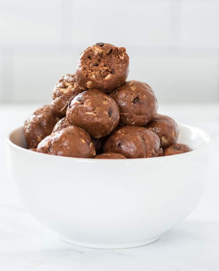protein balls stacked in a white bowl