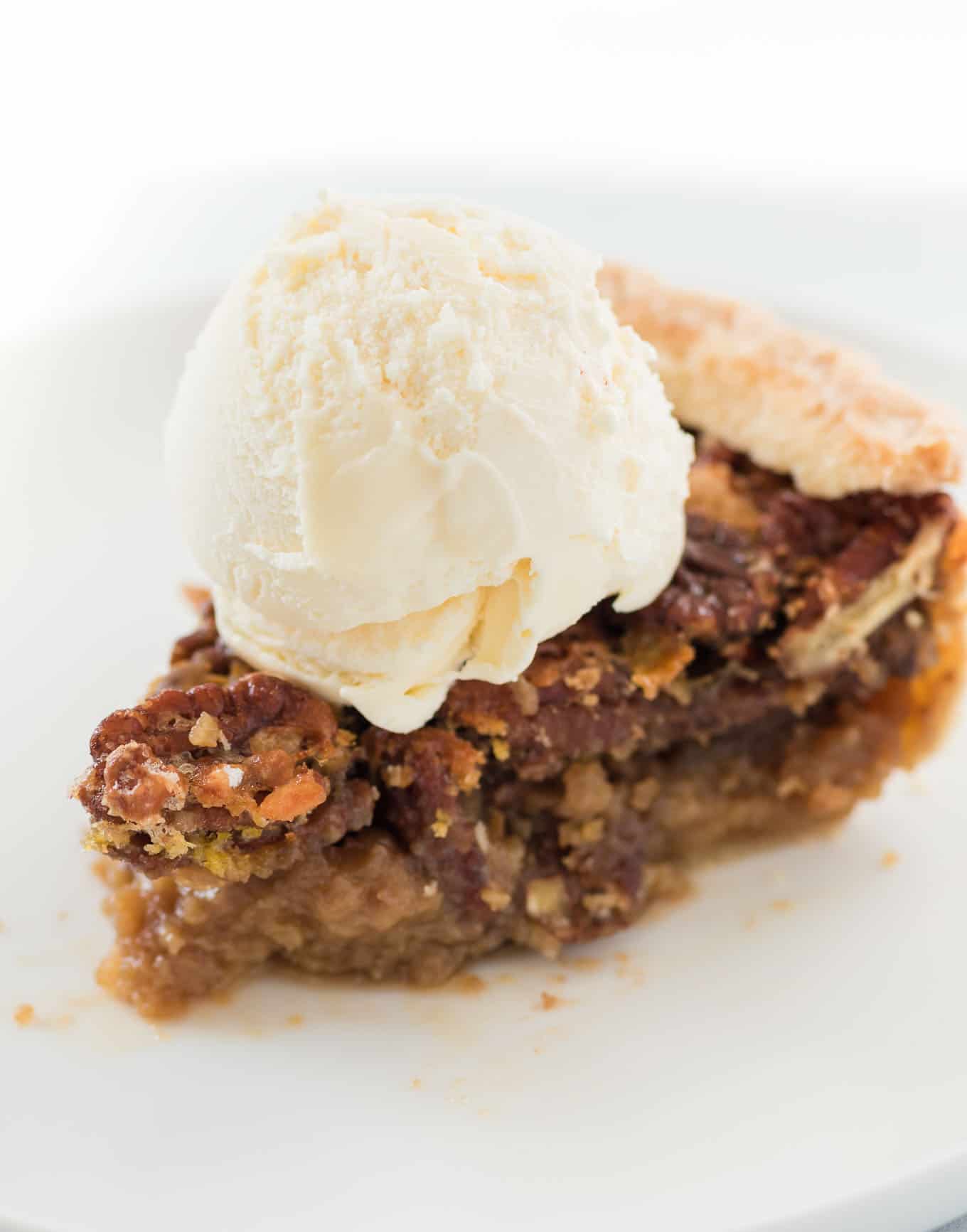 slice of pecan pie with a scoop of vanilla ice cream