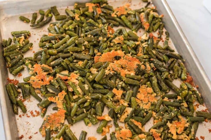 roasted green beans with parmesan on a baking sheet