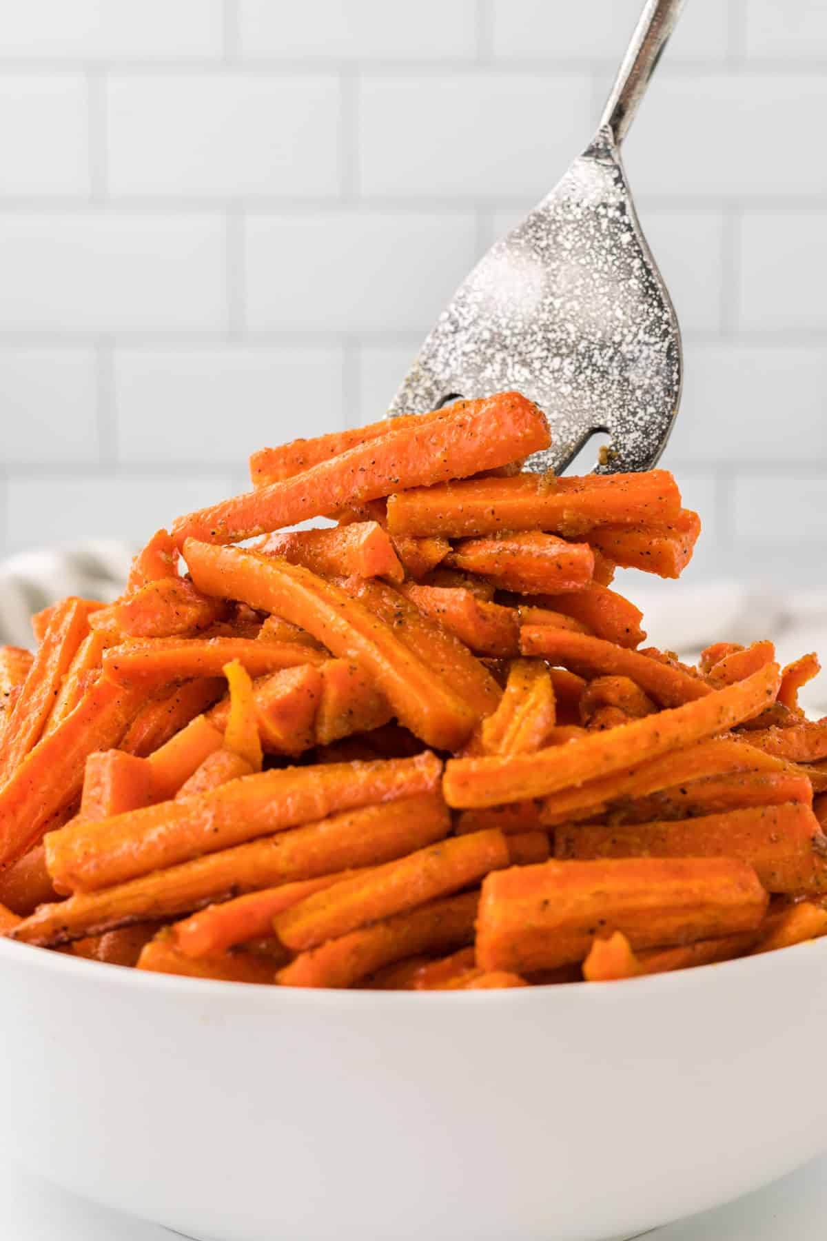 taking roasted carrots from the bowl