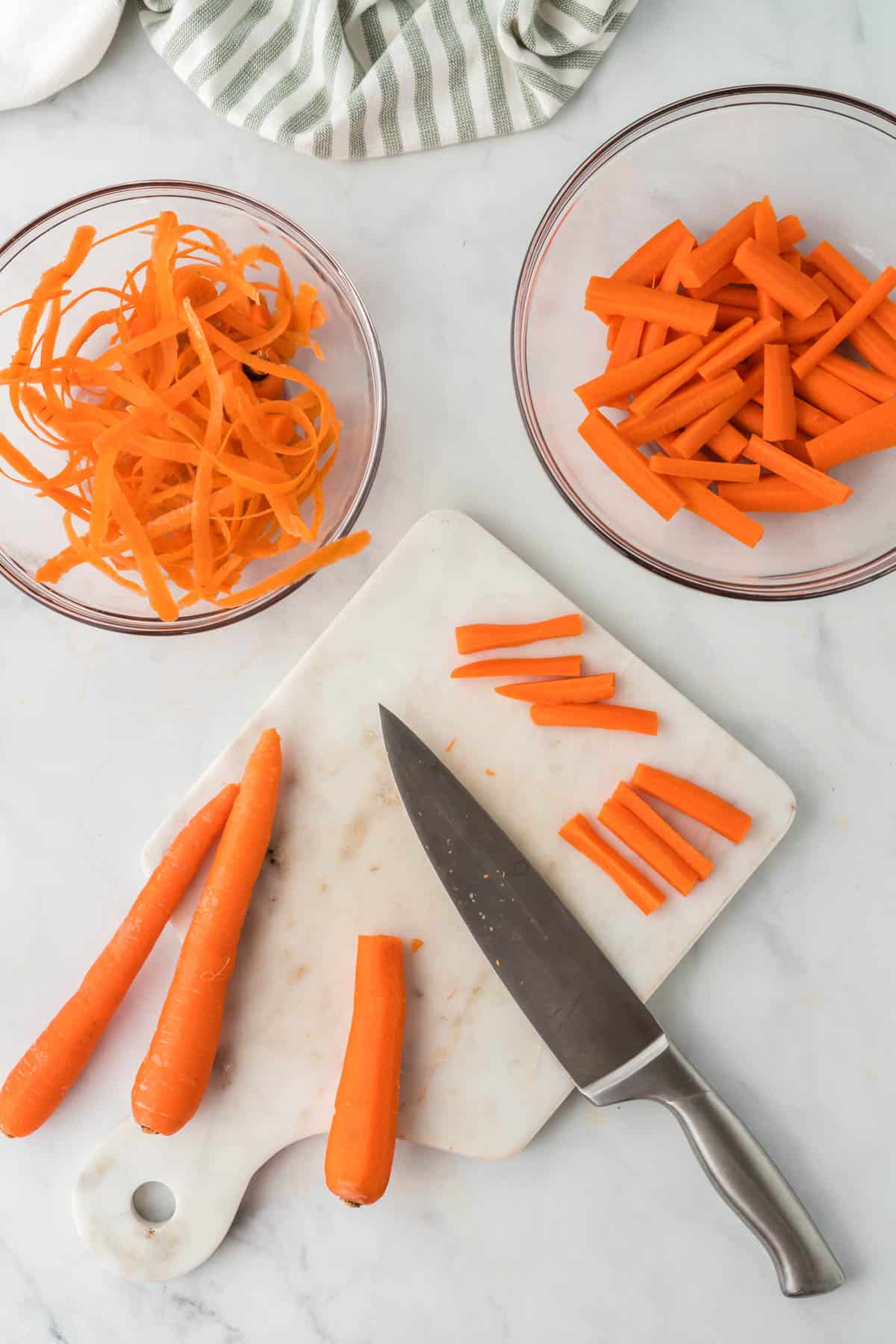 carrots being cut up on a cutting board