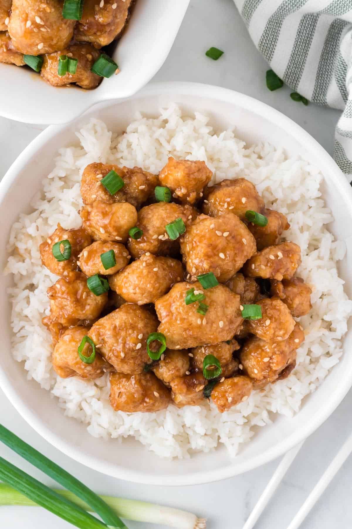 teriyaki cauliflower over rice in a white bowl