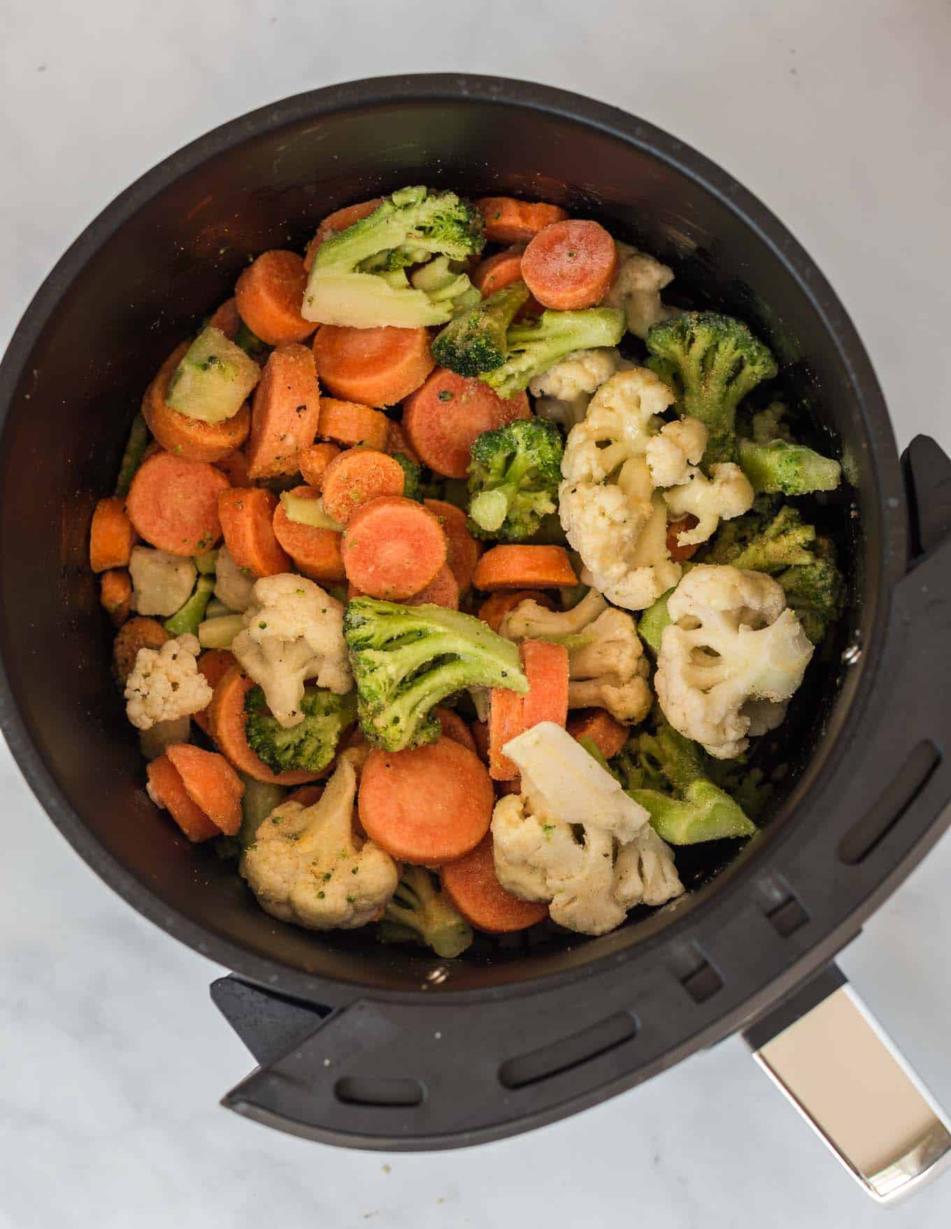 frozen mixed vegetables in an air fryer basket