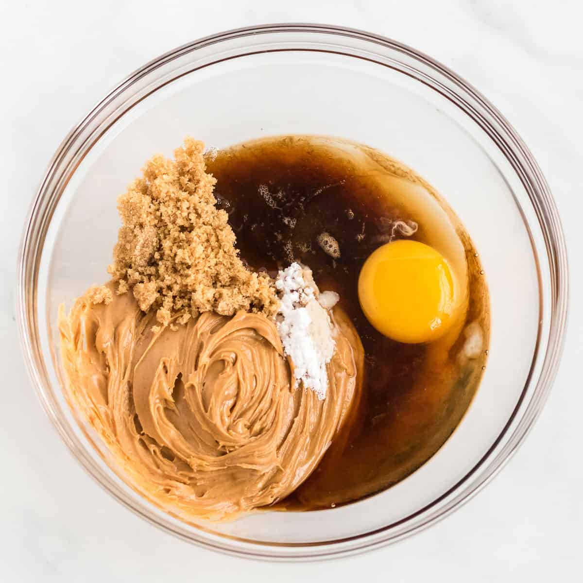 adding the cookie ingredients to a mixing bowl