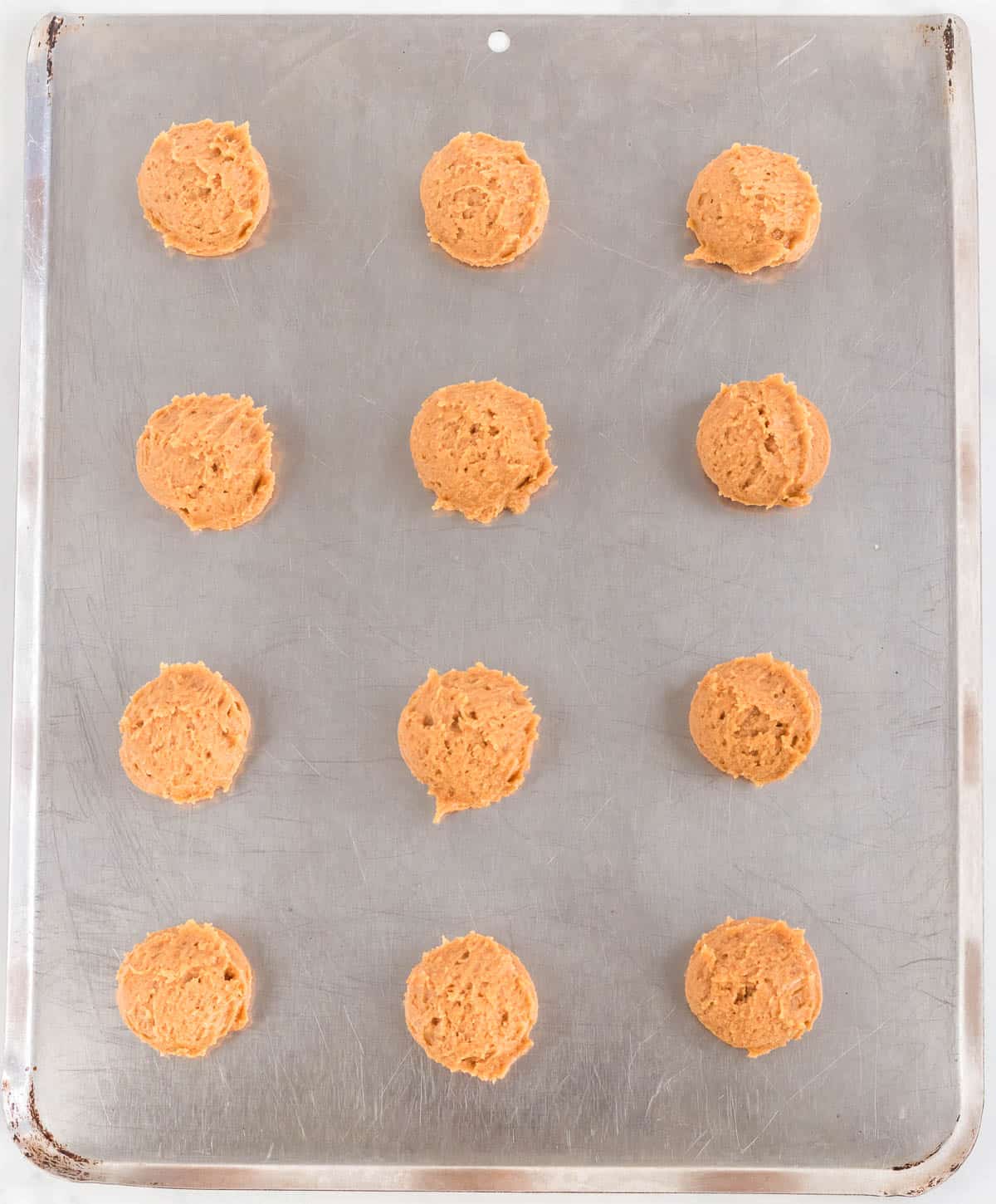 balls of cookie dough on a baking sheet