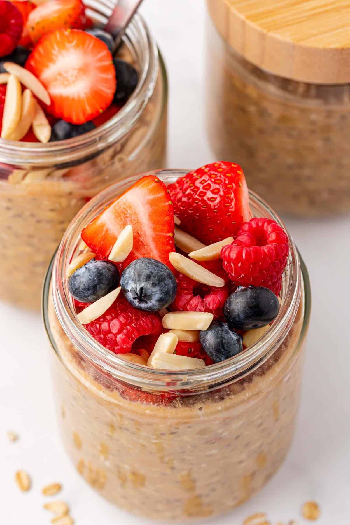 protein overnight oats topped with berries and almonds